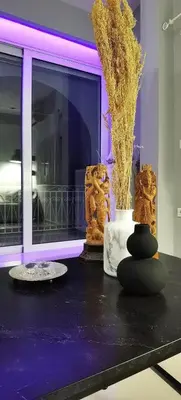 a table with some sculptures on it with purple lights at Divine Home Beach Retreat in Anavissos