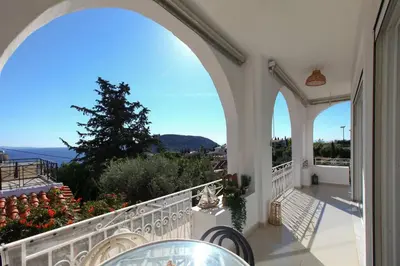a balcony with an archway and a view of the ocean at Divine Home Beach Retreat in Anavissos