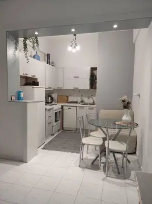 a kitchen with a table and chairs in a room at M.V Apartment in Athens