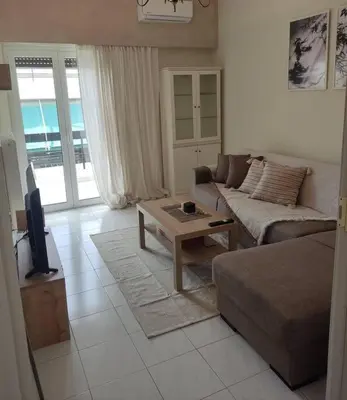 a living room with a couch and a coffee table at M.V Apartment in Athens