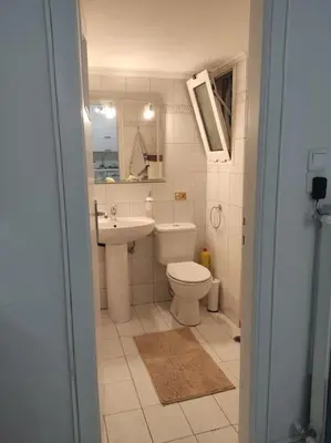 a bathroom with a toilet and a sink at M.V Apartment in Athens