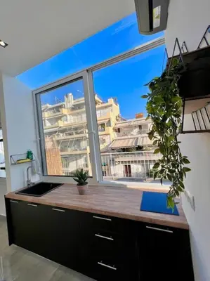 a kitchen with a large window and a sink at Athens Acropolis View in Athens
