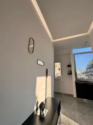 a living room with a black table and a window at Athens Acropolis View in Athens