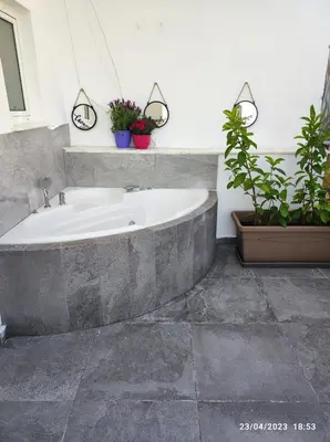 a bath tub in a bathroom with potted plants at Athens Acropolis View in Athens