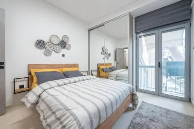 a bedroom with a large bed and a large window at Ano Patisia Station Studio in Athens
