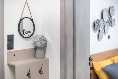 a bedroom with a mirror on the wall and a shelf at Ano Patisia Station Studio in Athens