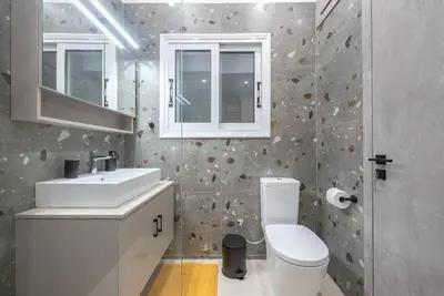 a bathroom with a white toilet and a sink at Ano Patisia Station Studio in Athens