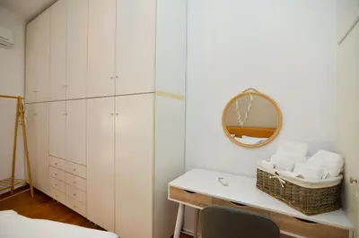 a bedroom with white cabinets and a mirror at Athens Stylish next to Acropolis, Metro stop Fix in Athens
