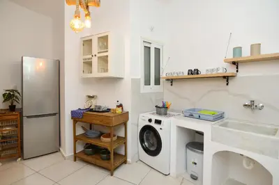 a kitchen with a washing machine and a refrigerator at Athens Stylish next to Acropolis, Metro stop Fix in Athens