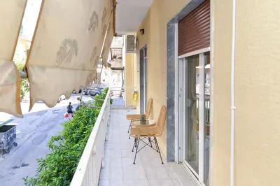 a balcony with chairs and tables on a building at Athens Stylish next to Acropolis, Metro stop Fix in Athens