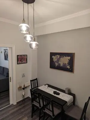 a dining room with a table and chairs in a room at Cozy apartm.near Metro Ag.Marina in Athens