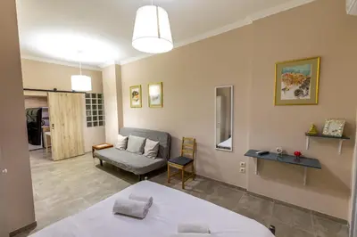 a room with a bed and a chair and a couch at Oasis in the centre in Athens
