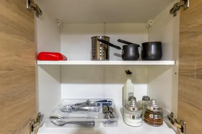 a kitchen shelf with utensils and pots and pans at Oasis in the centre in Athens
