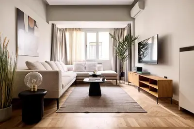 a living room with a couch and a table at Lime Residences, Syntagma by Aura Homes in Athens