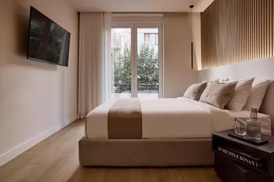 a bedroom with a large bed and a window at Lime Residences, Syntagma by Aura Homes in Athens