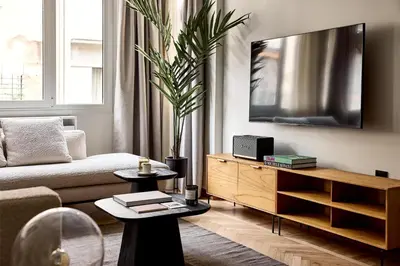 a living room with a couch and a tv at Lime Residences, Syntagma by Aura Homes in Athens
