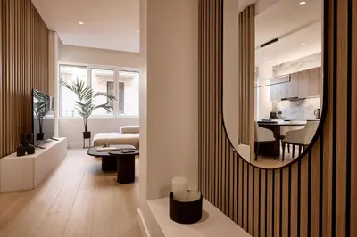 a living room with a mirror on a wall at Lime Residences, Syntagma by Aura Homes in Athens