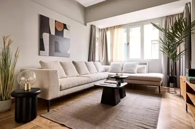 a living room with a couch and two tables at Lime Residences, Syntagma by Aura Homes in Athens