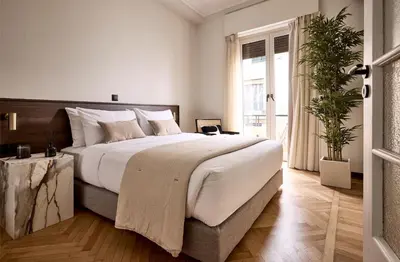 a bedroom with a large bed and a large window at Lime Residences, Syntagma by Aura Homes in Athens