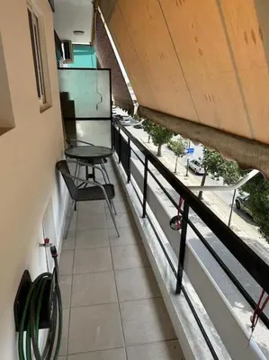 a room with a table and chairs on a balcony at Mihaela-Andreea Luxury House in Athens
