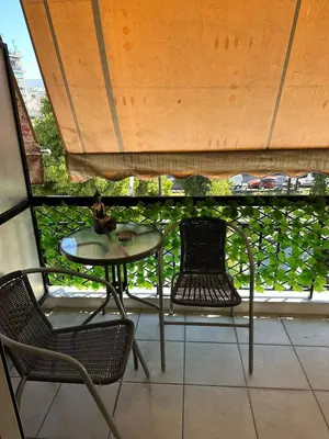 a table and chairs sitting on a balcony at Mihaela-Andreea Luxury House in Athens