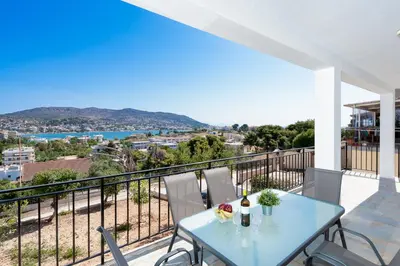a table and chairs on a balcony with a view at Zen Hilltop by A&D Properties in Porto Rafti