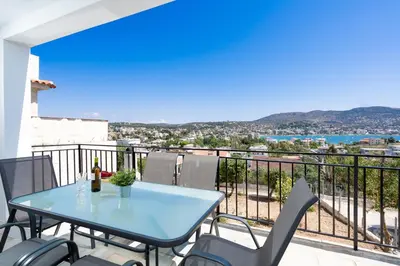 a blue table and chairs on a balcony with a view at Zen Hilltop by A&D Properties in Porto Rafti