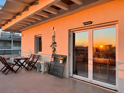 a patio with a table and chairs on a balcony at Quiet house-Athens Center 100 meters balcony on the top floor in Athens