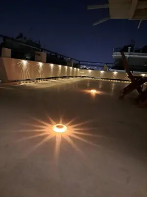 a light in the middle of a parking lot at night at Quiet house-Athens Center 100 meters balcony on the top floor in Athens