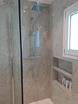 a shower with a shower head in a bathroom at Quiet house-Athens Center 100 meters balcony on the top floor in Athens