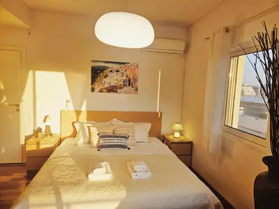 a bedroom with a bed with two towels on it at Quiet house-Athens Center 100 meters balcony on the top floor in Athens