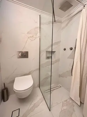 a bathroom with a toilet and a glass shower at Sunny Apartment in Koukaki - Excellent spot in Athens