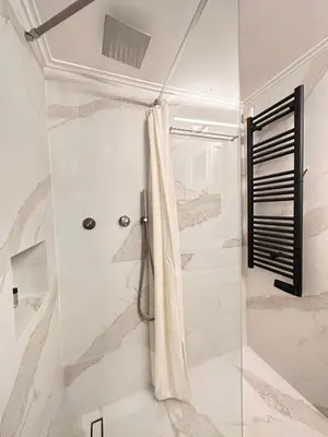 a bathroom with a shower with a shower curtain at Sunny Apartment in Koukaki - Excellent spot in Athens