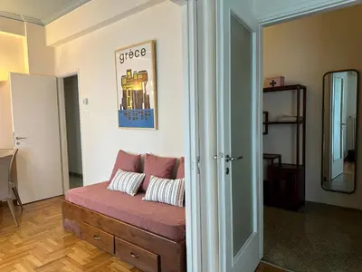a living room with a couch in a room at Sunny Apartment in Koukaki - Excellent spot in Athens