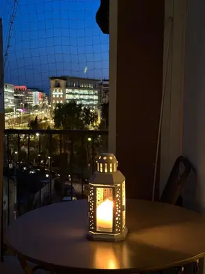 a lantern sitting on top of a table with a window at Sunny Apartment in Koukaki - Excellent spot in Athens