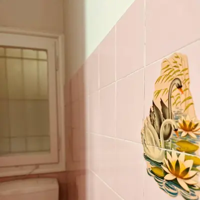 a bathroom with a bowl of flowers on the wall at Grandma's Apartment in Athens