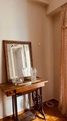 a mirror on a table in a room at Grandma's Apartment in Athens