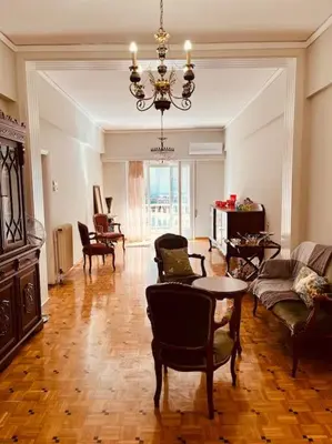 a living room filled with furniture and a chandelier at Grandma's Apartment in Athens