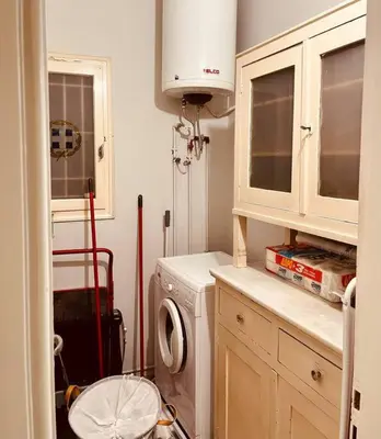 a kitchen with a washing machine in a kitchen at Grandma's Apartment in Athens