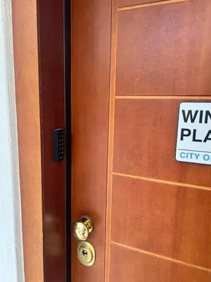 a sign on a wooden door with a virus plan sign on it at WINDSOR PLACE APARTMENT - KEYLESS ENTRY with code in Athens