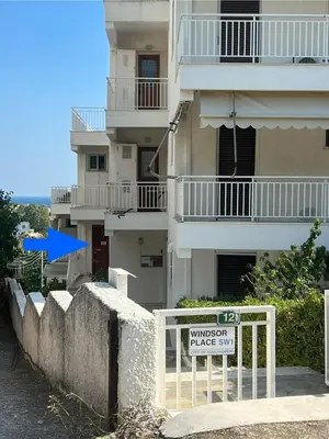 a building with a sign in front of it at WINDSOR PLACE APARTMENT - KEYLESS ENTRY with code in Athens