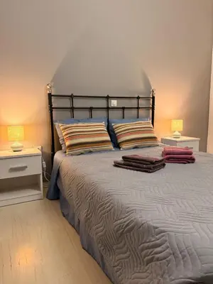 a bedroom with a large bed with two night stands at WINDSOR PLACE APARTMENT - KEYLESS ENTRY with code in Athens