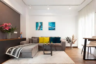 a living room with a couch and a table at Seaside Apartment by Flisvos Marina in Athens