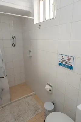 a bathroom with a toilet and a bath tub at Bluehouse in Porto Rafti