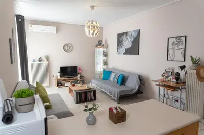 a living room with a couch and a table at Bluehouse in Porto Rafti