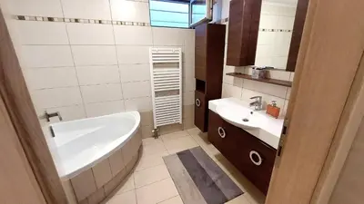 a bathroom with a bath tub and a sink at Luxury apartment SEA HELM with private swimming pool and BBQ in Lagonissi