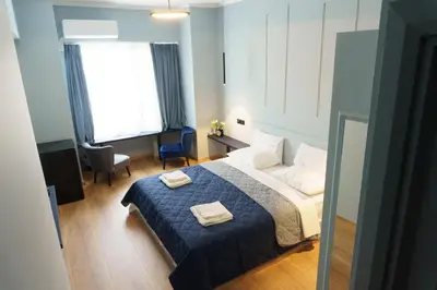 a bedroom with a bed with two towels on it at Sani Deluxe Suites Home- Monastiraki Square - Brand New Home in Athens