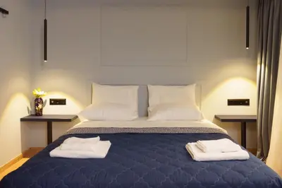 a bedroom with a bed with two towels on it at Sani Deluxe Suites Home- Monastiraki Square - Brand New Home in Athens
