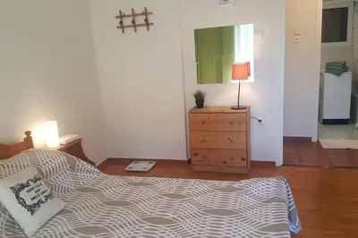 a bedroom with a bed and a dresser and a mirror at Athenslander Acropolis view in Athens