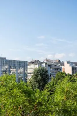 a city skyline with tall buildings in the background at Athenslander Acropolis view in Athens